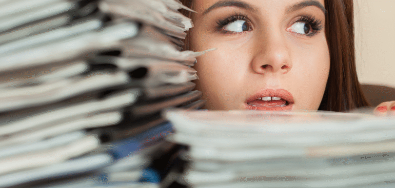 Woman looking at books stacked
