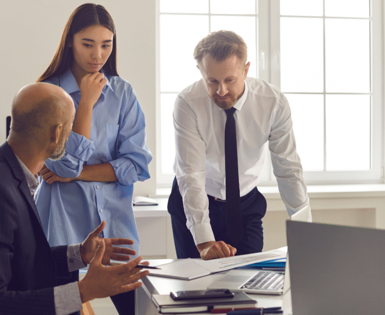 Boss looking over at coworkers - Coach2Consulting Bookkeeping in Colorado