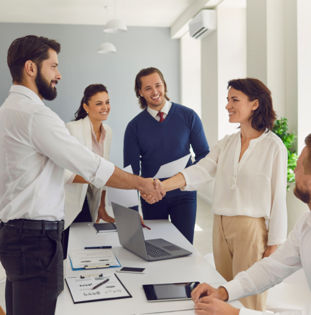 Woman shaking man's hand in an office