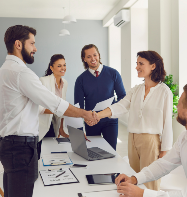 Woman shaking man's hand in an office