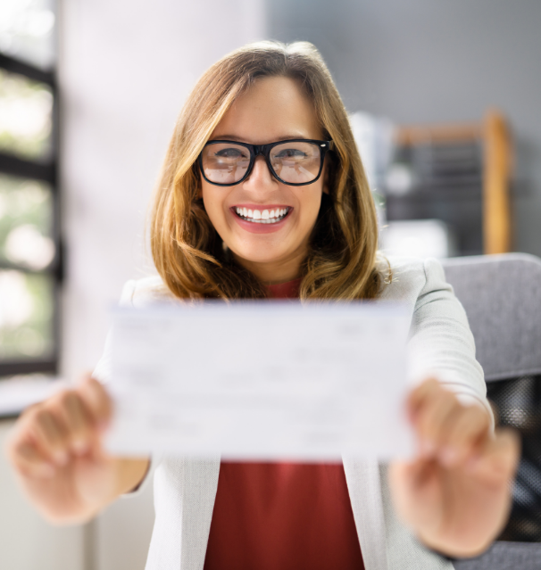 Woman with glasses holding check